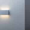 A,glowing,modern,aluminum,led,lamp,on,the,gray,wall.